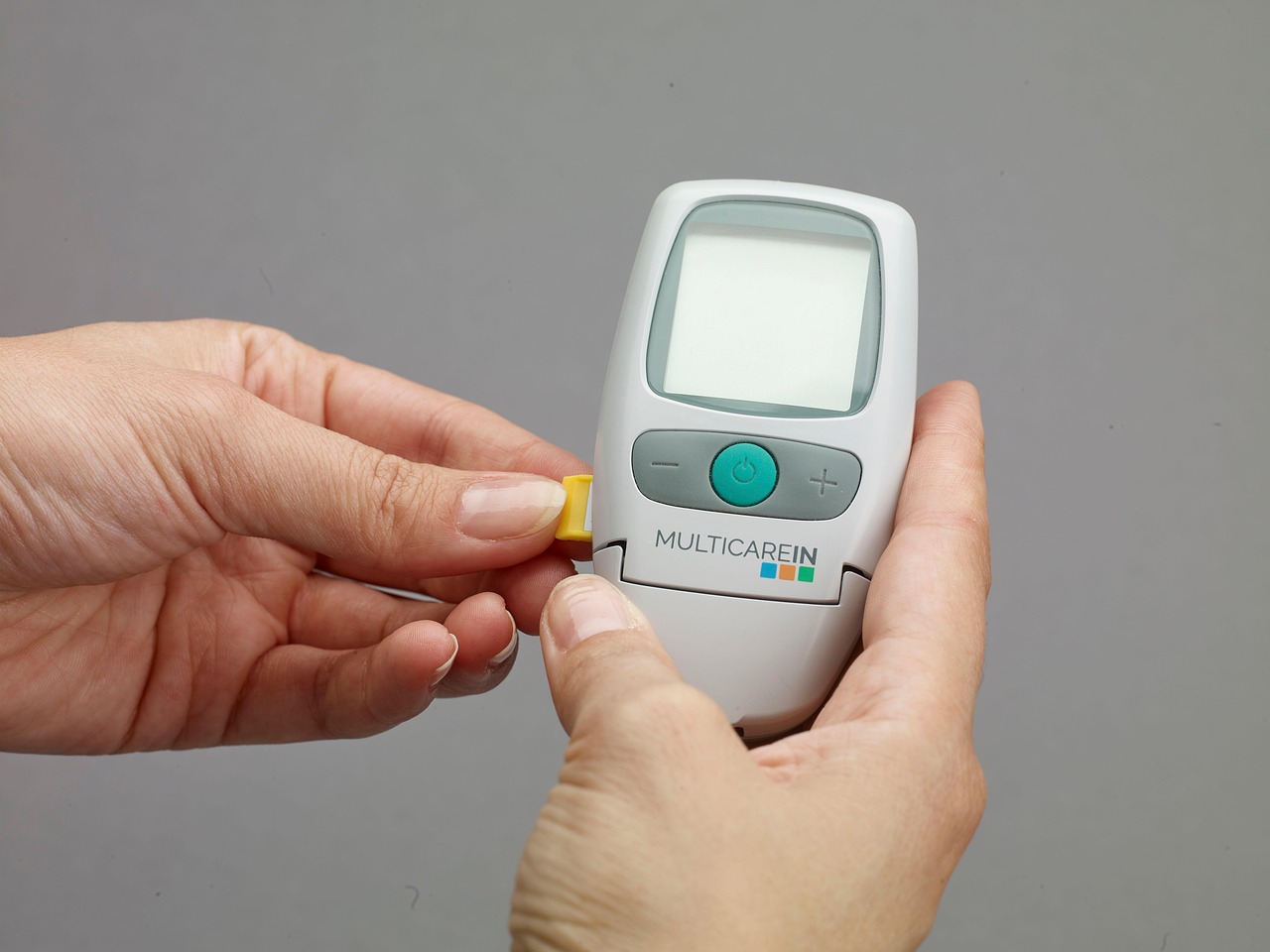 A handheld TDS meter showing a measurement of dissolved solids in water